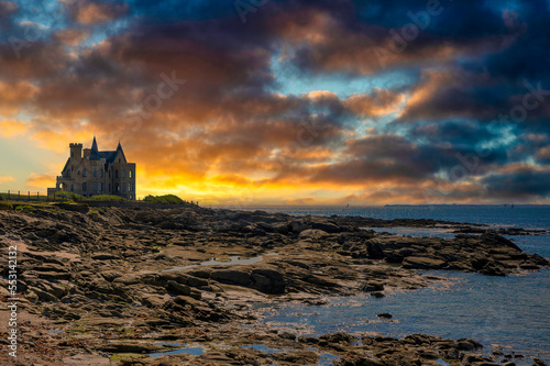 France, Brittany, Quiberon, Dramatic clouds over Chateau Turpault at dusk photo