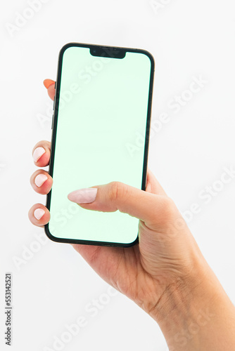 hand holding green screen phone