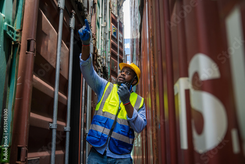 Foreman checking loading Containers box for Cargo freight ship for import export,Foreman inspect Industrial Container Cargo.