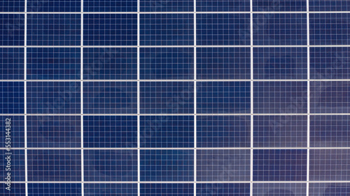 Aerial perpendicular view of solar panels installed on a roof. Solar energy accumulators. Green economy concept.