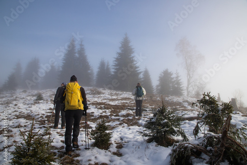 man trekking in foggy winter landscape in the mountains
