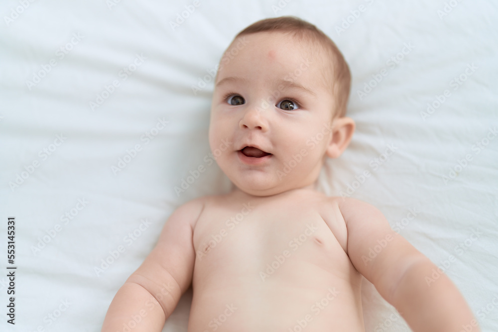 Adorable toddler smiling confident lying on bed at bedroom Adorable toddler smiling confident lying on bed at bedroom