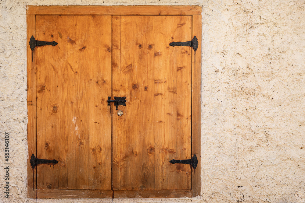 closed window lids in stone wall closed window lids in stone wall