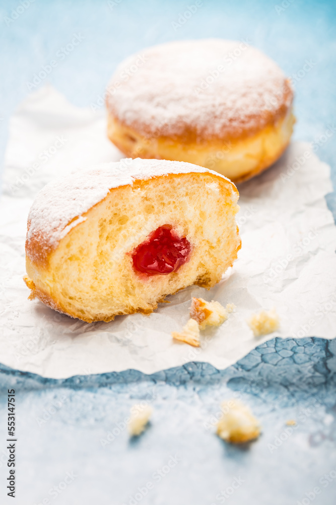 German donuts - berliner filled with strawberry jam with icing sugar - obrazy, fototapety, plakaty 