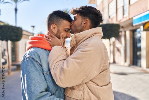 Two man couple hugging each other standing at street © Krakenimages.com