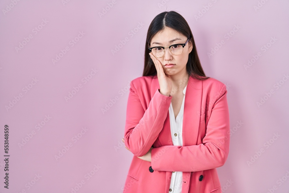 Chinese business young woman wearing glasses thinking looking tired and bored with depression problems with crossed arms.