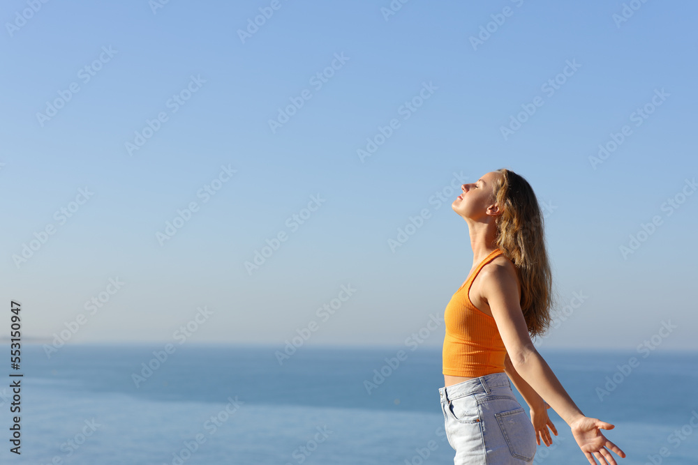 Teen breathing fresh air on the beach with horizon Teen breathing fresh air on the beach with horizon