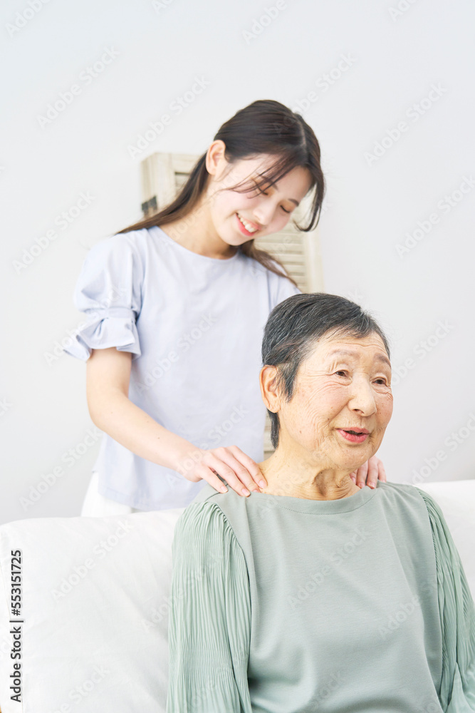 祖母の肩揉みをする孫 祖母の肩揉みをする孫