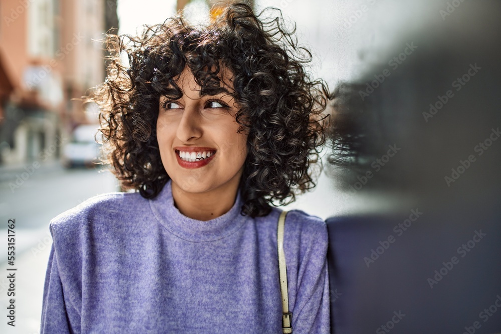 Young middle east woman smiling confident leaning on the wall at street Young middle east woman smiling confident leaning on the wall at street