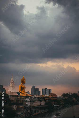 Bangkok, Thailand - December 12, 2022 : Big Golden Buddha statue along side canel in Bangkok