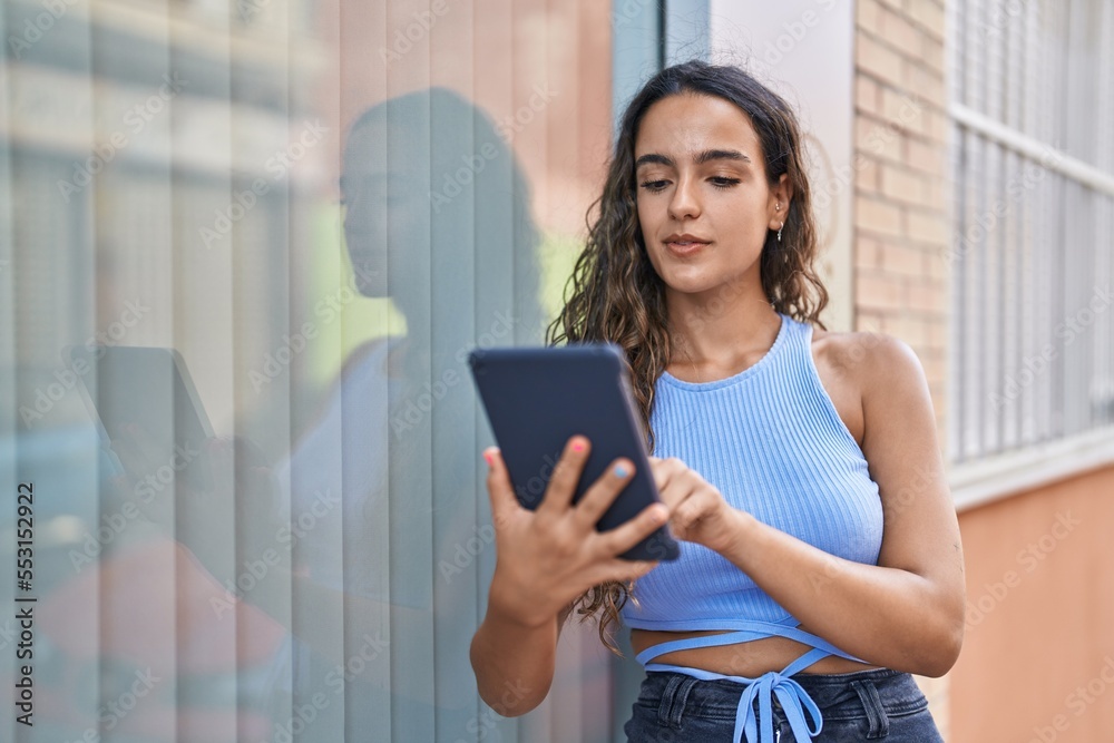 Young beautiful hispanic woman using touchpad at street Young beautiful hispanic woman using touchpad at street