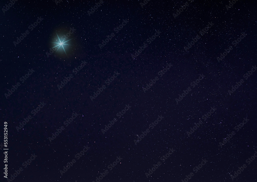 Bright blue star for Christmas in the night sky