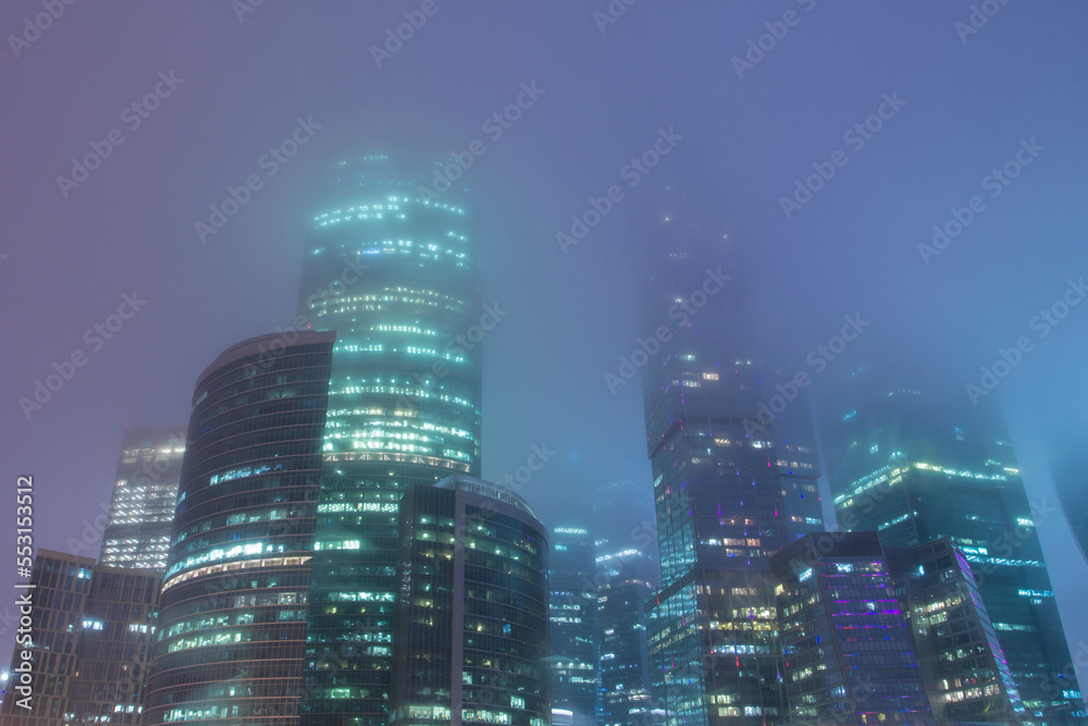 Obraz premium Mystical cityscape. Skyscrapers in the fog. Foggy view of the towers of the Moscow International Business Center Moscow City.