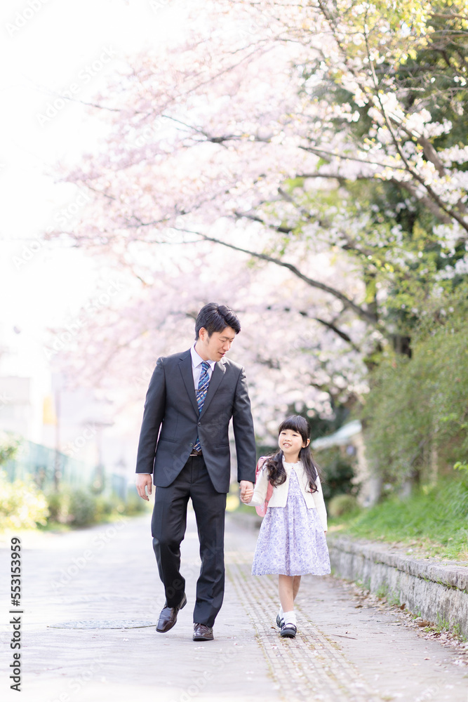 Fototapeta premium ランドセルを背負った女の子とスーツを着た父親
