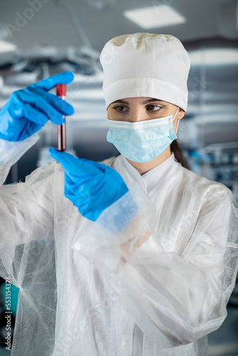 doctor holds a blood sample in a test tube in a surgical laboratory of a hospital working