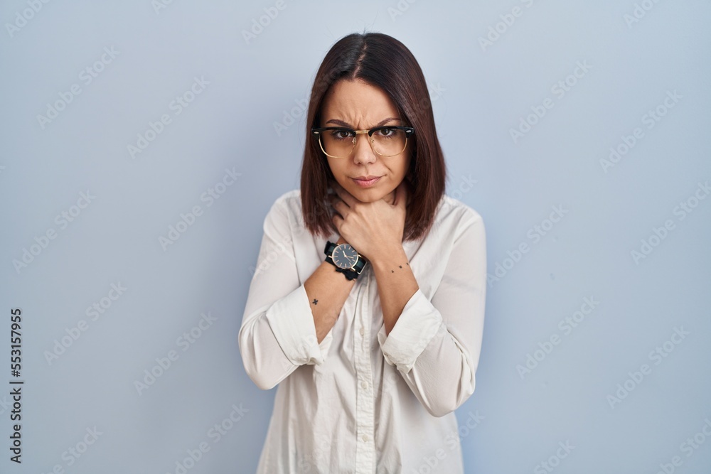 Young hispanic woman standing over white background shouting suffocate because painful strangle. health problem. asphyxiate and suicide concept. Young hispanic woman standing over white background shouting suffocate because painful strangle. health problem. asphyxiate and suicide concept.