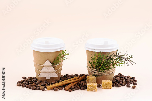 Winter coffee. Disposable cup for hot drink with Christmas decoration. Mockup take away coffee cup.