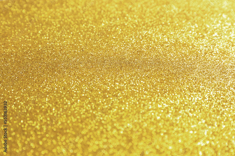 Beautiful golden shiny glitter as background, closeup