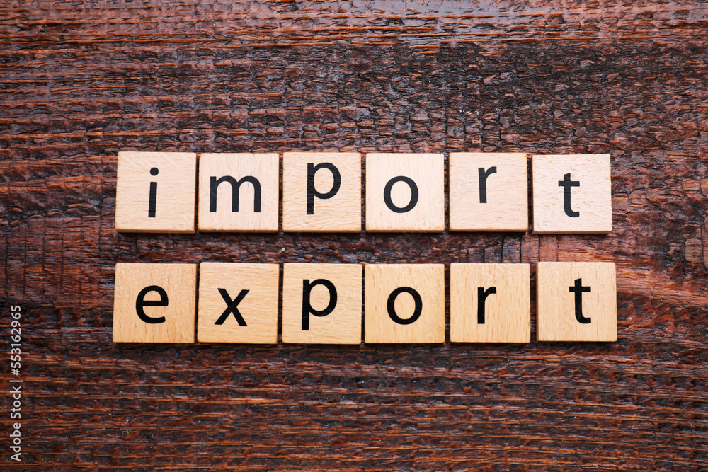 Fototapeta premium Words Import and Export made of cubes on wooden table, top view