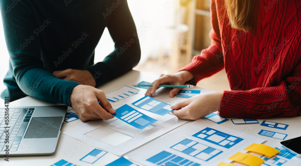 Fototapeta premium UX graphic designer planning application process development prototype wireframe for web smart phone. Creative digital development agency...