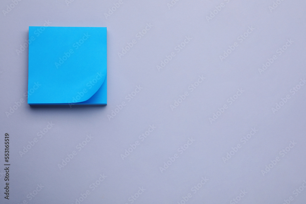 Paper note on light purple background, flat lay. Space for text Paper note on light purple background, flat lay. Space for text
