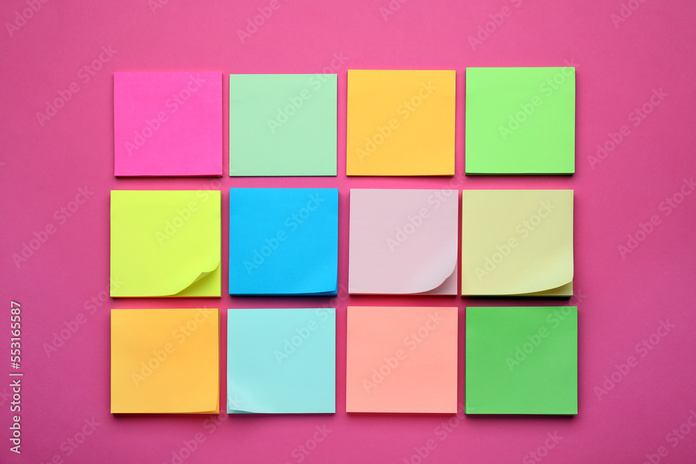 Colorful empty notes on pink background, flat lay Colorful empty notes on pink background, flat lay