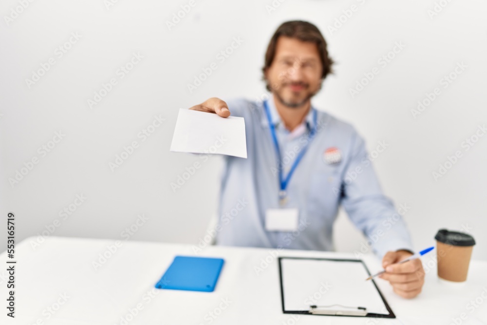 Middle age caucasian man smiling confident holding vote at electoral college Middle age caucasian man smiling confident holding vote at electoral college