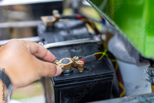 Mechanic checks the battery of a car before a trip. © Bluesky60