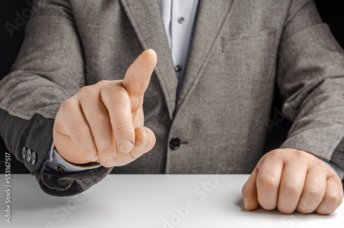 Businessman in a suit pointing with his finger