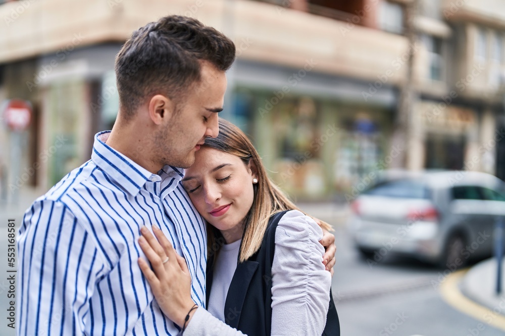 Man and woman couple smiling confident hugging each other at street Man and woman couple smiling confident hugging each other at street