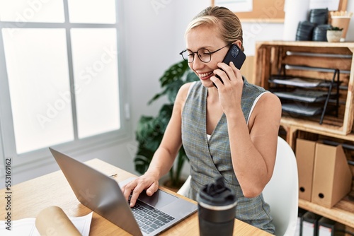 Young caucasian woman smiling confident talking on the smartphone working at architecture studio