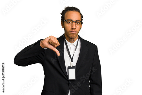 Young African American business man with badge isolated showing a dislike gesture, thumbs down. Disagreement concept.