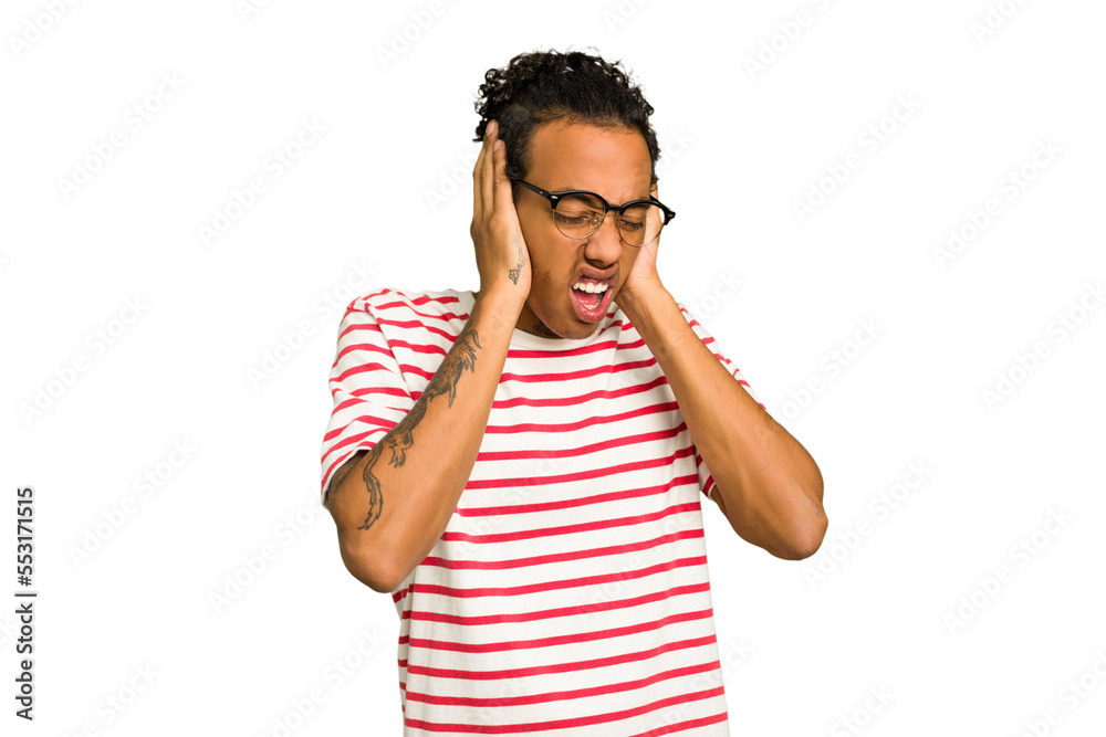 Young African American man isolated covering ears with hands trying not to hear too loud sound. Young African American man isolated covering ears with hands trying not to hear too loud sound.