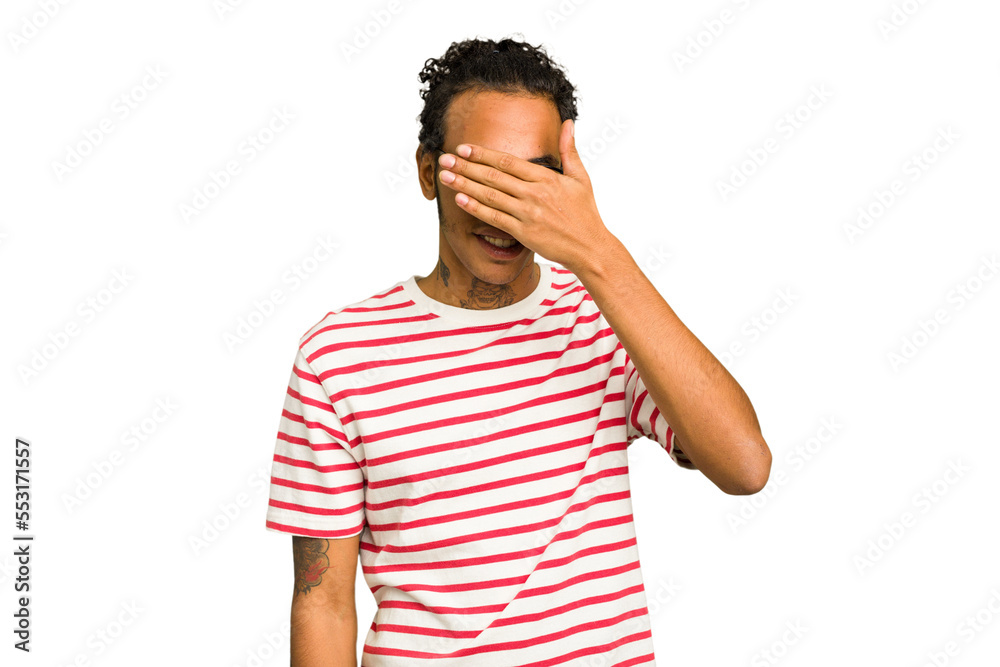 Young African American man isolated covers eyes with hands, smiles broadly waiting for a surprise.