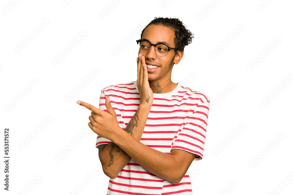 Young African American man isolated saying a gossip, pointing to side reporting something. Young African American man isolated saying a gossip, pointing to side reporting something.