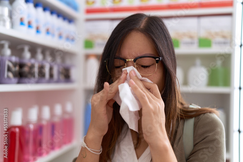 Young asian woman customer using nakpin at pharmacy © Krakenimages.com