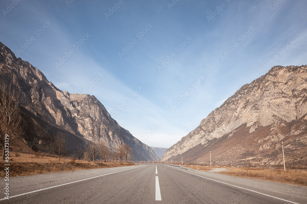 Empty road in mountains at sunny day