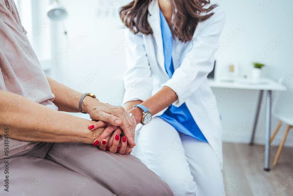 Cropped shot of an unrecognizable female nurse comforting a patient in the hospital. Health worker holding patient's hand. Cropped shot of a senior woman holding hands with a nurse