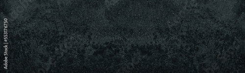 Black concrete wall. Dark gray rough cement distressed texture. Grunge textured panoramic background