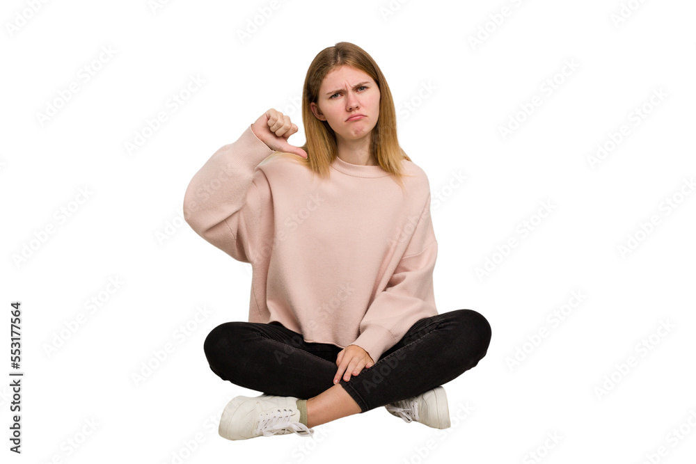Young caucasian woman sitting on the floor cutout isolated Young caucasian woman sitting on the floor cutout isolated
