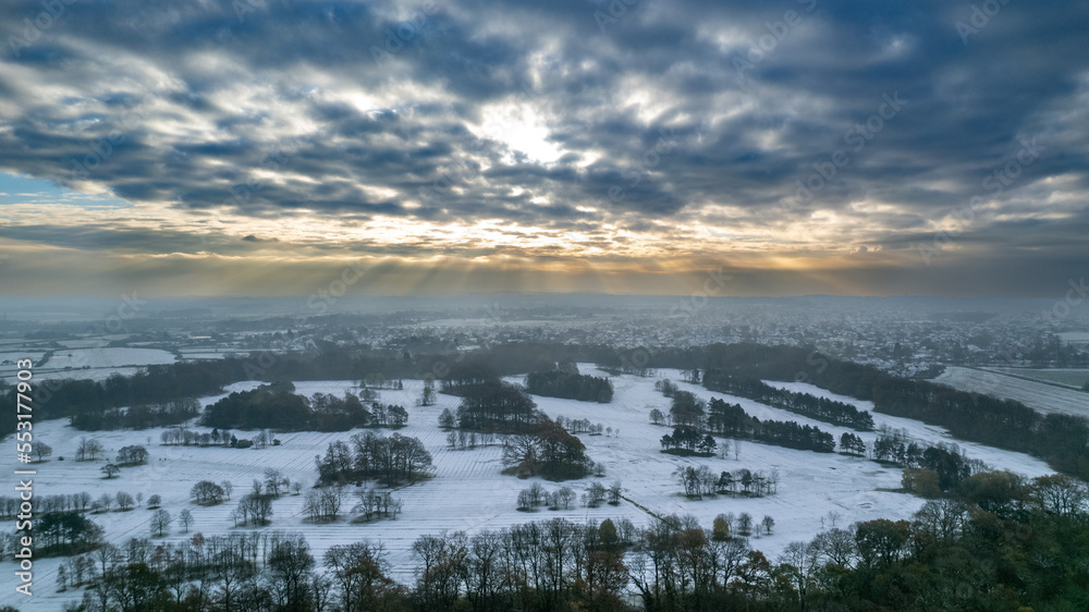 Rays of sunshine fall on the snowy hills of The Wirrall in the North of England