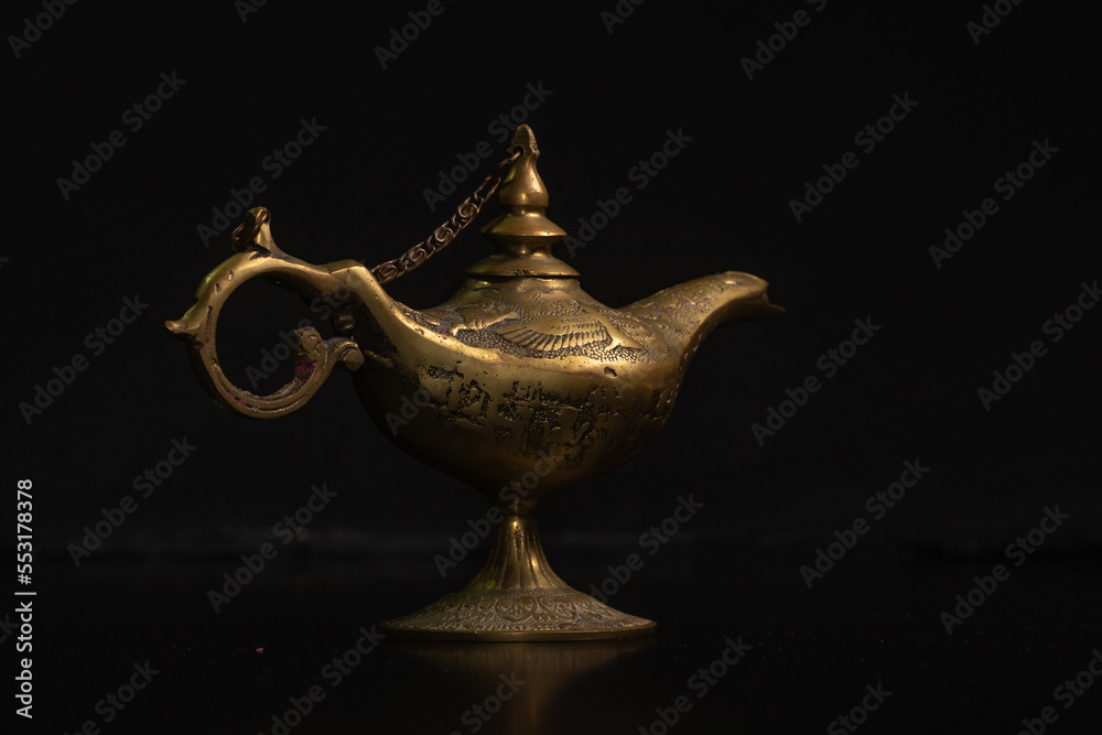Aladdin's magic lamp isolated on black background Aladdin's magic lamp isolated on black background