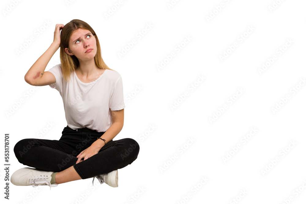 Fototapeta premium Young caucasian woman sitting on the floor cutout isolated