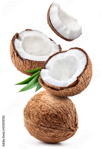 Coconut isolated. Coconut whole, half and piece with leaves on white background. Broken white coco flying. Full depth of field. photo