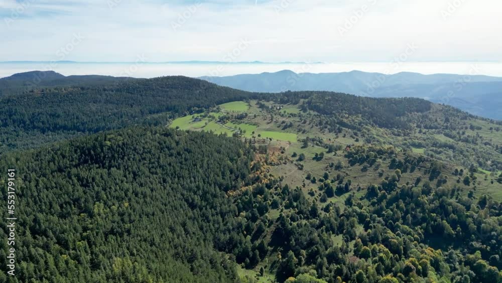 Aerial drone panoramic flight view over the Glasborn and the GR 532 hiking trail from the Col de Wettstein in Alsace summer, with sea of clouds, Black Forest and Vosges mountains in background Aerial drone panoramic flight view over the Glasborn and the GR 532 hiking trail from the Col de Wettstein in Alsace summer, with sea of clouds, Black Forest and Vosges mountains in background