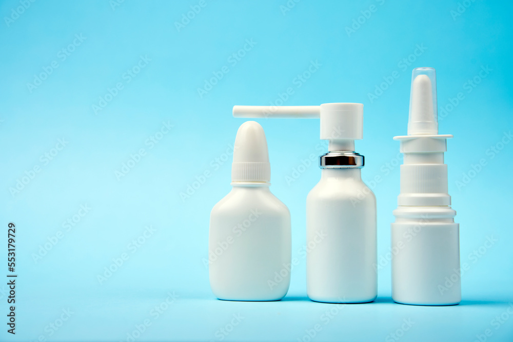 Nasal spray bottle on blue background with copy space Nasal spray bottle on blue background with copy space