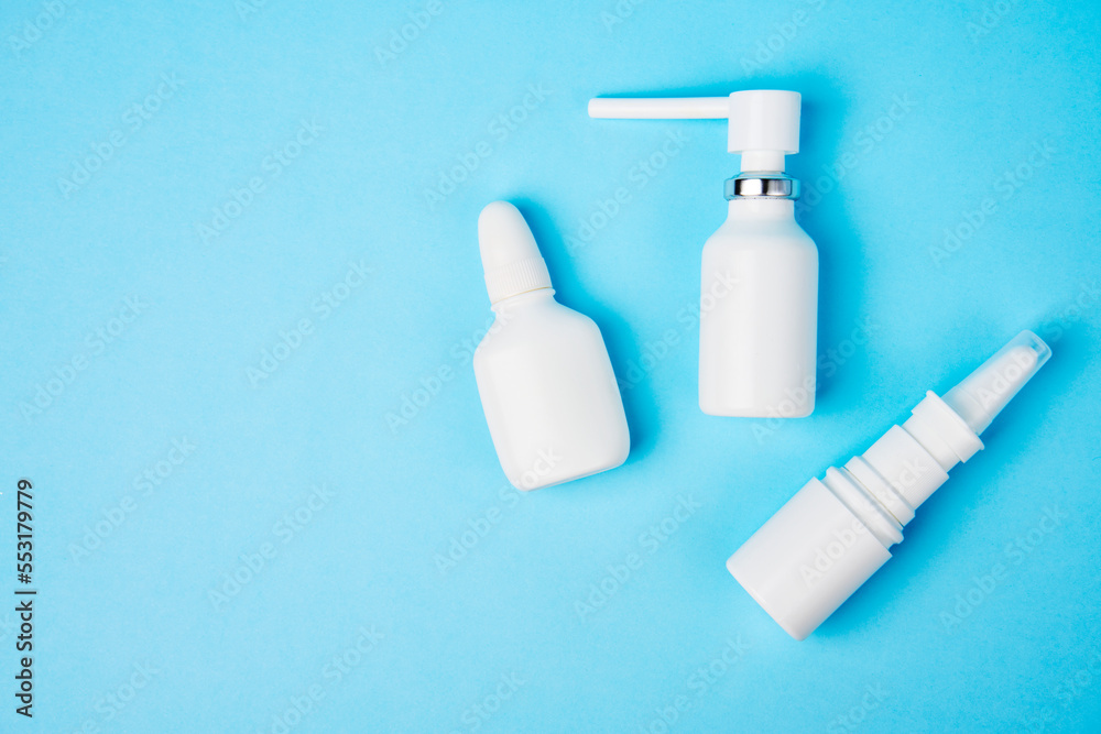Nasal spray bottle on blue background with copy space Nasal spray bottle on blue background with copy space
