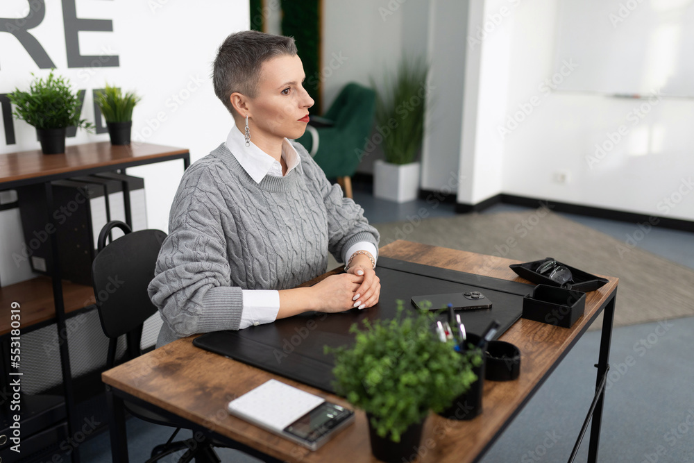woman worker in the office sitting at the table woman worker in the office sitting at the table