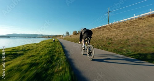 FPV following Jake the Fixedgear Biker next to Danube River during sunny autumn day. photo