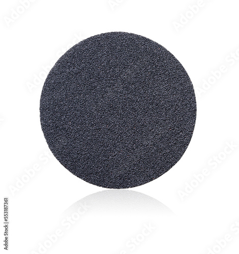Sandpaper. Round sanding paper with Velcro, isolated on white background. Fine grains of sand are visible on the surface of the sandpaper. Abrasive disc. Round abrasive paper.
